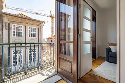 a door to a balcony with a view of a building at The Flat in Porto