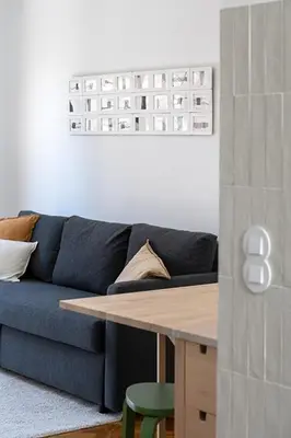 a living room with a blue couch and a table at The Flat in Porto