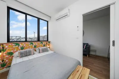 a living room with a couch and a kitchen at Constituição Flat by Amber Star Rent in Porto