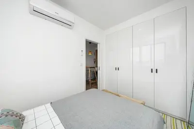 a bedroom with a bed and a large window at Constituição Flat by Amber Star Rent in Porto