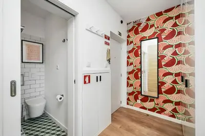 a bathroom with a toilet and a mirror at Constituição Flat by Amber Star Rent in Porto