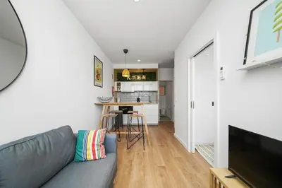 a living room with a couch and a tv at Constituição Flat by Amber Star Rent in Porto
