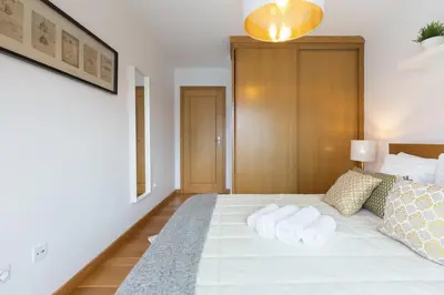 a bedroom with a bed with towels on it at Host Wise - Deluxe Modern Flat w Balcony in Porto