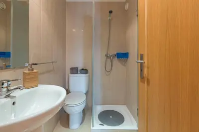 a bathroom with a toilet and a sink and a shower at Host Wise - Deluxe Modern Flat w Balcony in Porto