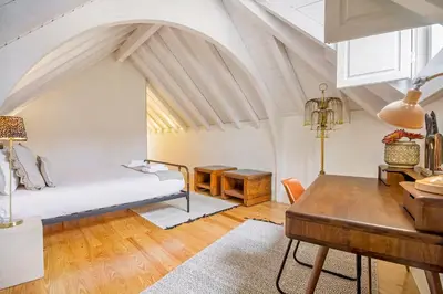 a bedroom with a bed and a desk in a room at Mouzinho 202 in Porto