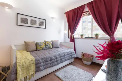 a living room with a couch and a window at Host Wise - Cool Flat - City Center near Aliados in Porto