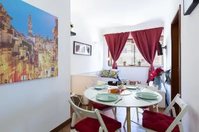 a dining room with a white table and chairs at Host Wise - Cool Flat - City Center near Aliados in Porto