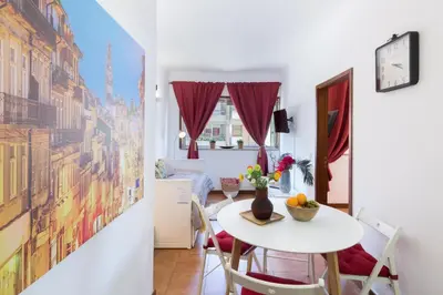 a small dining room with a white table and chairs at Host Wise - Cool Flat - City Center near Aliados in Porto