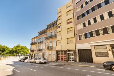 a street with cars parked on the side of a building at Lusi'Apartment - Douro River so close by Guest SPA in Porto