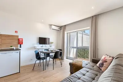 a living room with a couch and a table at Lusi'Apartment - Douro River so close by Guest SPA in Porto