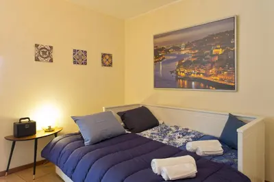 a bedroom with a purple bed and a table at Host Wise - Spacious Trendy Flat w Netflix - Central Location in Porto