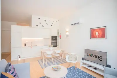 a living room with a table and a kitchen at Liiiving in Porto - Haven Pool Apartment in Porto