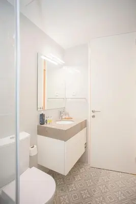a white bathroom with a sink and a toilet at Liiiving in Porto - Haven Pool Apartment in Porto