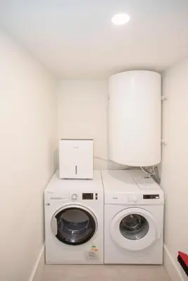 a washer and dryer in a small room at Liiiving in Porto - Haven Pool Apartment in Porto