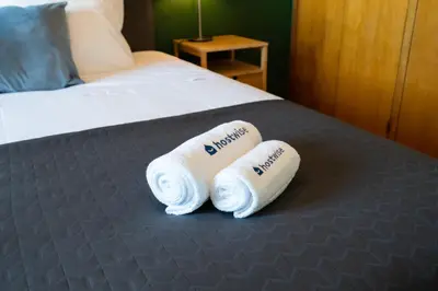 two rolled towels on a bed in a hotel room at Host Wise - Fantastic Peaceful Flat in Gaia in Vila Nova de Gaia