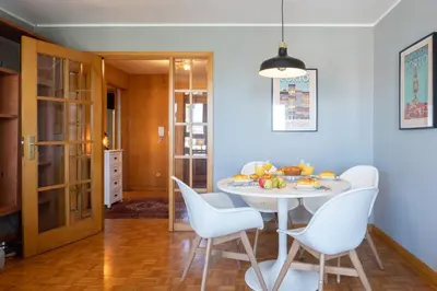 a dining room with a white table and chairs at Host Wise - Fantastic Peaceful Flat in Gaia in Vila Nova de Gaia