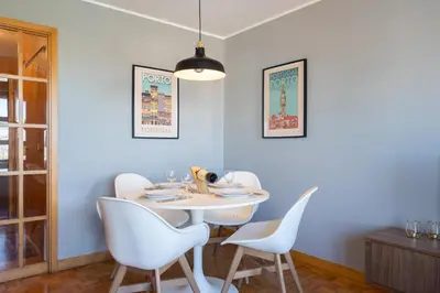 a dining room with a white table and chairs at Host Wise - Fantastic Peaceful Flat in Gaia in Vila Nova de Gaia