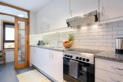 a white kitchen with a stove and a sink at Host Wise - Fantastic Peaceful Flat in Gaia in Vila Nova de Gaia