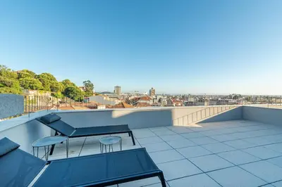 a balcony with chairs and a view of a city at Large Terrace in Paraiso III in Porto