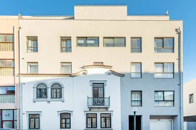 a large white building with a balcony on it at Large Terrace in Paraiso III in Porto
