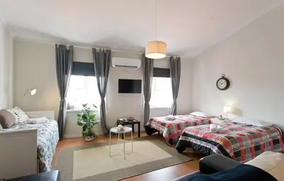 a living room with two beds and a couch at Host Wise - Cozy Sunny Flats - Ace Location in Porto