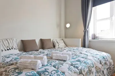 a bedroom with a large bed with towels on it at Host Wise - Cozy Sunny Flats - Ace Location in Porto
