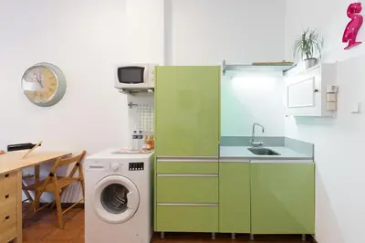 a kitchen with a washing machine and a sink at Host Wise - Cozy Sunny Flats - Ace Location in Porto
