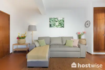 a living room with a couch and a table at Host Wise - Comfy Bright Flats with Netflix in Porto