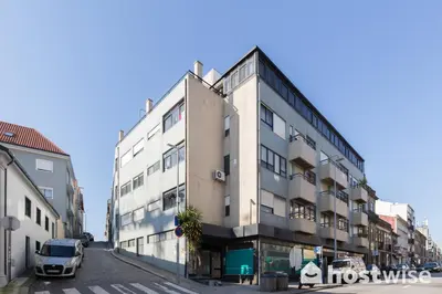 a white van parked in front of a building at Host Wise - Comfy Bright Flats with Netflix in Porto