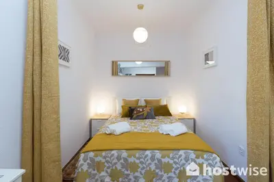 a bedroom with a bed with two night stands at Host Wise - Comfy Bright Flats with Netflix in Porto