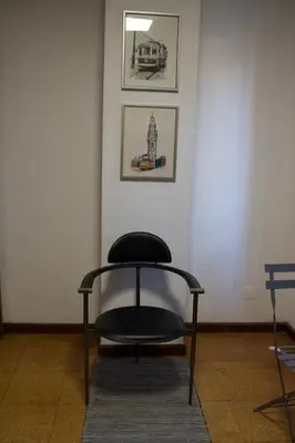 a chair in a room with two pictures on the wall at Jardim do Morro Places in Vila Nova de Gaia