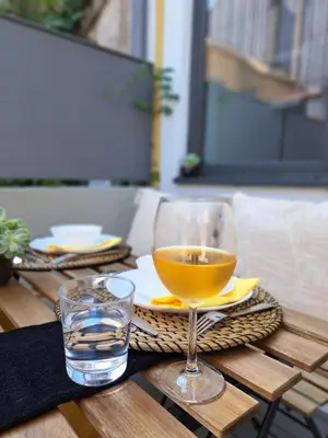 a glass of wine sitting on top of a table at Boavista Luxury Villas in Porto