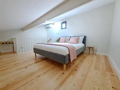 a bedroom with a bed with pink pillows on it at Boavista Luxury Villas in Porto