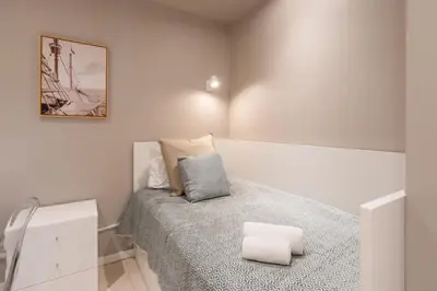 a bedroom with a bed with two towels on it at Carolina Roomy & Modern Apartment in Porto