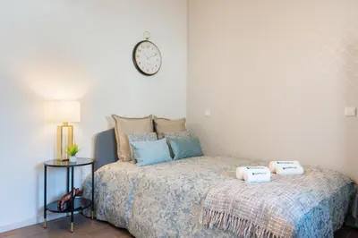 a bedroom with a bed with a clock on the wall at Host Wise - Impressive Restful Houses in Porto