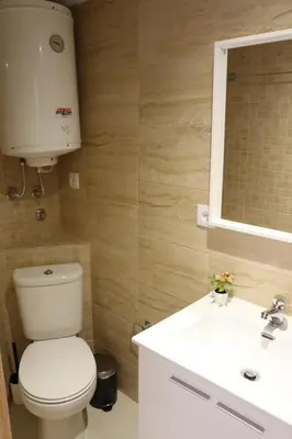 a bathroom with a toilet and a sink and a mirror at Casas da Corujeira in Porto