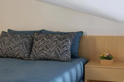 a bed with a pillow on top of it at Casas da Corujeira in Porto