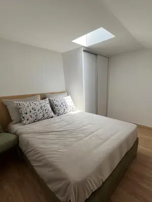a bedroom with a large white bed with pillows at Casas da Corujeira in Porto