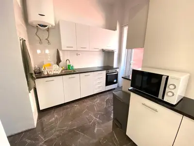 a kitchen with white cabinets and a microwave at BREINER 54 in Porto