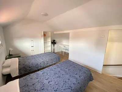 a small bedroom with two beds and a table at BREINER 54 in Porto