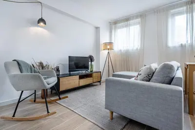 a living room with a couch and a tv at Nomads Lux - 1BDR Charming Top Floor Porto in Porto
