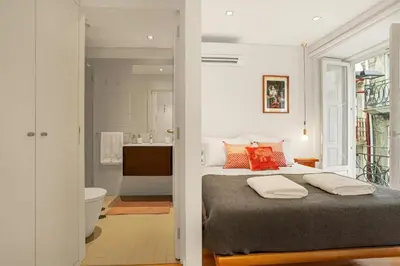 a bedroom with a bed and a bathroom at Host Wise - Lovely Shinny Flats with Balcony - Clerigos in Porto