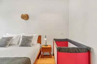 a bedroom with a bed and a table with a lamp at Host Wise - Lovely Shinny Flats with Balcony - Clerigos in Porto