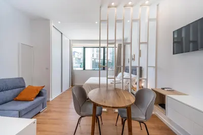 a living room with a table and chairs and a couch at Window to Porto by Amber Star Rent in Porto