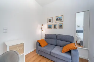 a living room with a couch and a mirror at Window to Porto by Amber Star Rent in Porto