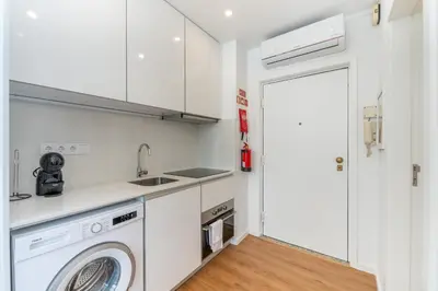 a kitchen with a washing machine and a sink at Window to Porto by Amber Star Rent in Porto