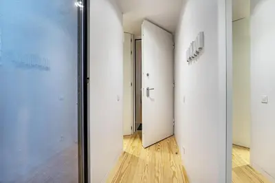 a hallway with white doors and a wooden floor at Nomad's Lux - Almada Apartments Porto in Porto