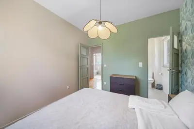 a bedroom with a white bed and a chandelier at New Apartments Luiz I Bridge by Amber Star Rent in Vila Nova de Gaia
