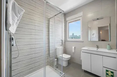 a bathroom with a shower and a toilet and a sink at New Apartments Luiz I Bridge by Amber Star Rent in Vila Nova de Gaia