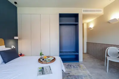 a bedroom with a bed and a table and chairs at Aspasios Bonjardim Apartments in Porto